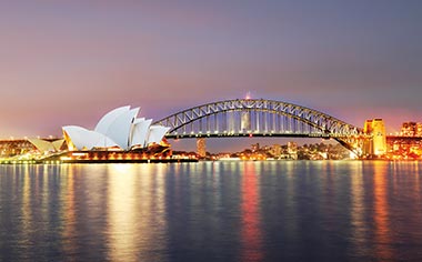 The Opera House and Harbour Bridge in Sydney, Australia illuminated at dusk